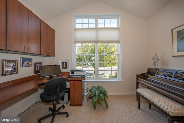 office space with light colored carpet and lofted ceiling