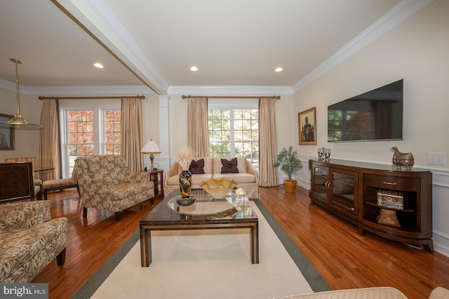 living room with hardwood / wood-style floors and ornamental molding