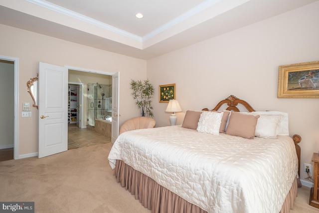 bedroom with ornamental molding, light carpet, and connected bathroom