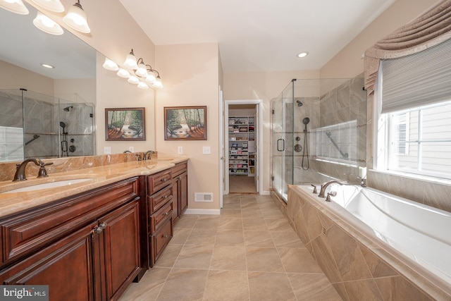 bathroom with vanity and separate shower and tub