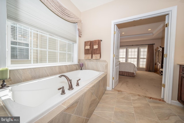 bathroom featuring tiled tub