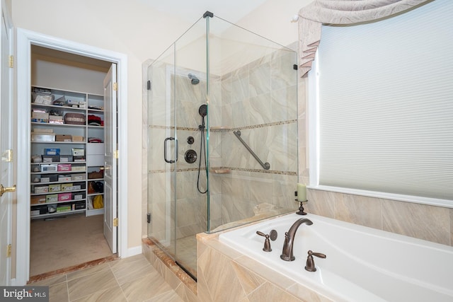 bathroom featuring tile patterned floors and shower with separate bathtub