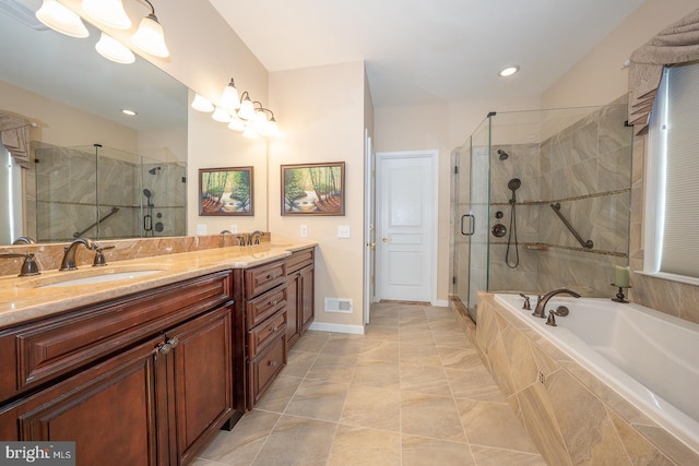 bathroom with tile patterned floors, vanity, and shower with separate bathtub