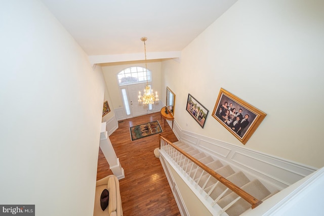 entrance foyer with hardwood / wood-style floors and an inviting chandelier