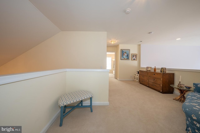 living area with light carpet and lofted ceiling