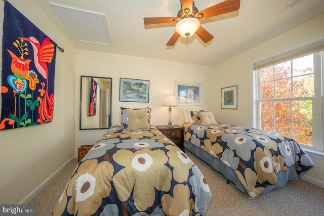 carpeted bedroom featuring multiple windows and ceiling fan