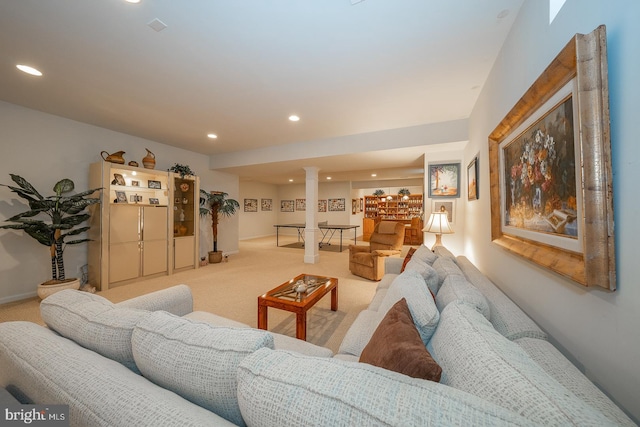 living room featuring light colored carpet and decorative columns