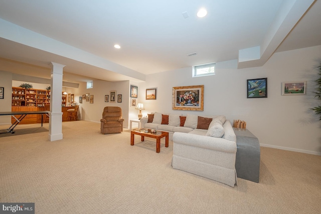 carpeted living room featuring ornate columns