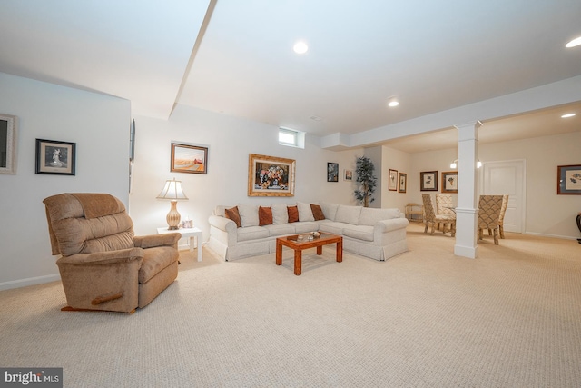 living room with light colored carpet and decorative columns