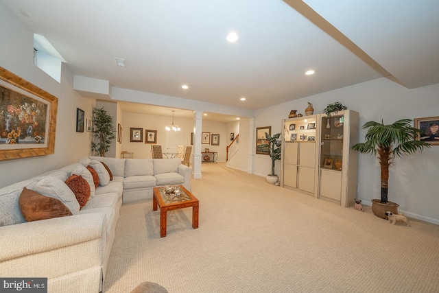 living room featuring ornate columns and light carpet