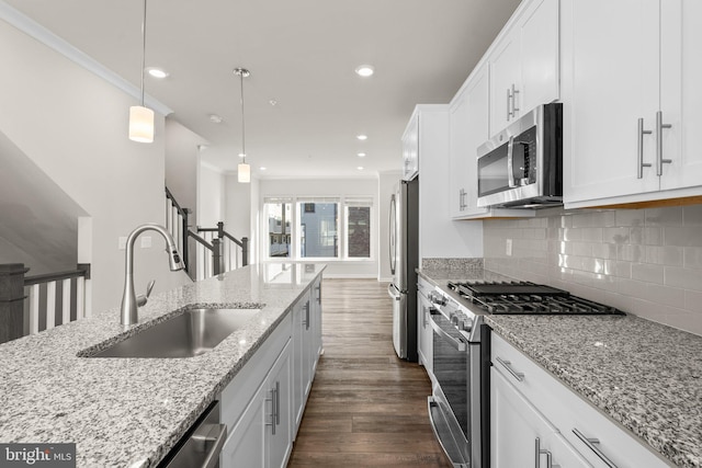 kitchen featuring stainless steel appliances, sink, and white cabinets