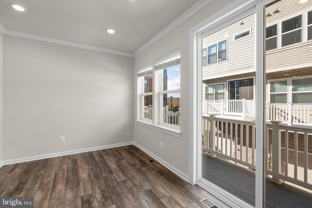 empty room with dark wood-type flooring and crown molding