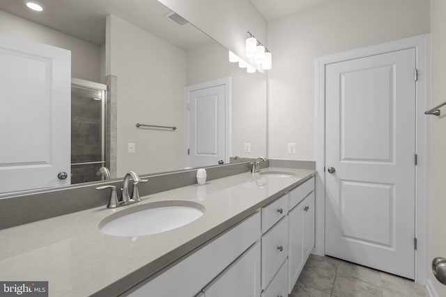 bathroom featuring vanity, tile patterned flooring, and an enclosed shower