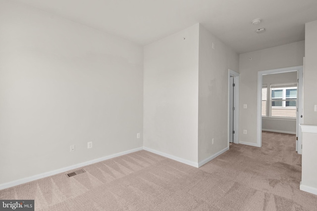 unfurnished room with light carpet