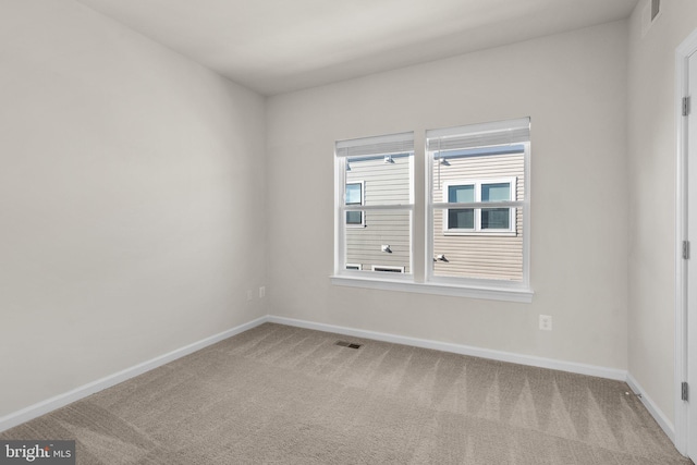 empty room featuring light colored carpet