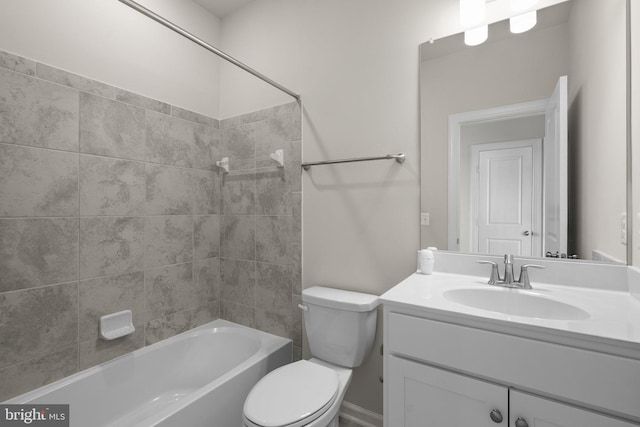 full bathroom featuring toilet, tiled shower / bath, and vanity