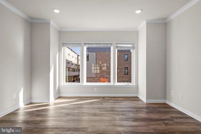 empty room with ornamental molding and dark wood-type flooring