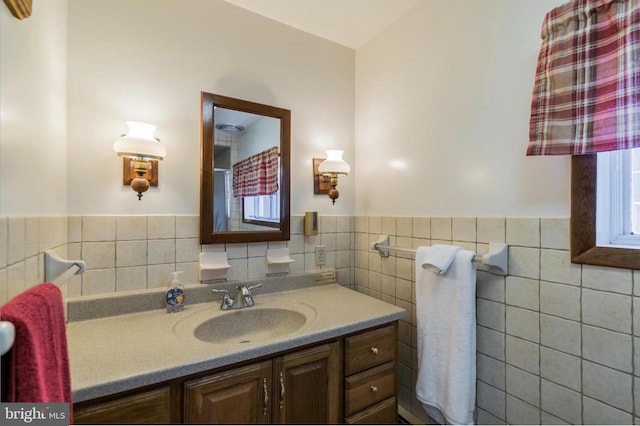 bathroom with vanity and tile walls