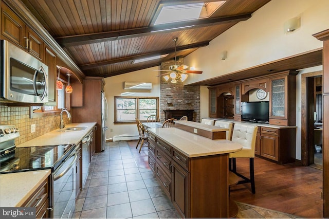 29 Boulder Rd, Upper Black Eddy, PA 18972 - kitchen with a sink, stainless steel appliances, a brick fireplace, wooden ceiling, and tasteful backsplash