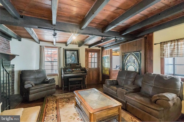 living room with wood ceiling, hardwood / wood-style floors, and beam ceiling