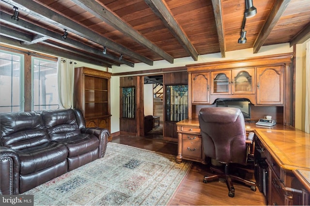 office space featuring beam ceiling, wooden ceiling, track lighting, and dark hardwood / wood-style floors