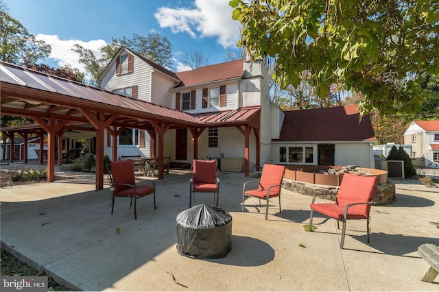 view of patio with an outdoor fire pit and a gazebo