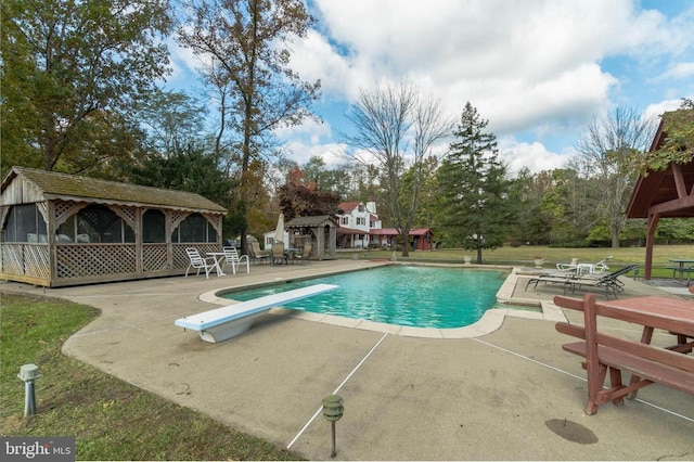 view of pool with a gazebo, a patio area, a lawn, and a diving board