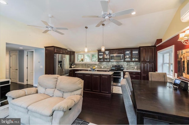 kitchen with dark brown cabinetry, stainless steel appliances, dark wood-type flooring, and pendant lighting