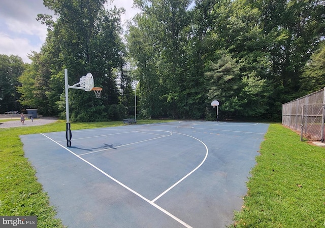 view of sport court with a yard