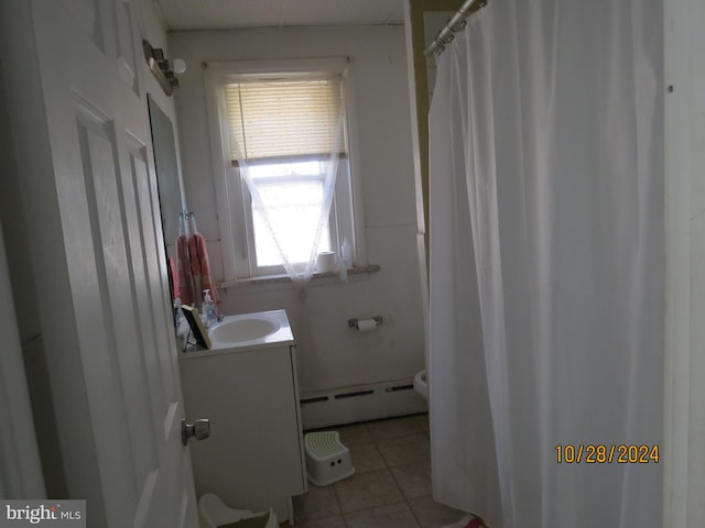 bathroom with vanity, a baseboard heating unit, a shower with shower curtain, and tile patterned floors