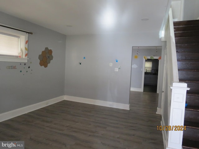 empty room with dark hardwood / wood-style flooring