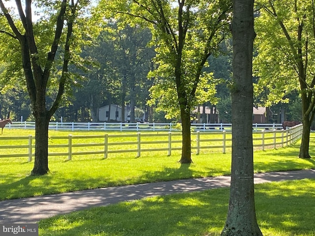 surrounding community with a yard and a rural view