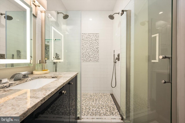 bathroom featuring vanity and a shower with shower door