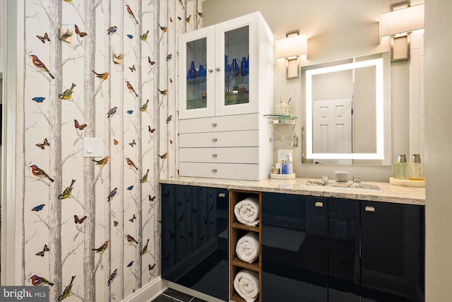 bathroom with tile patterned flooring and vanity