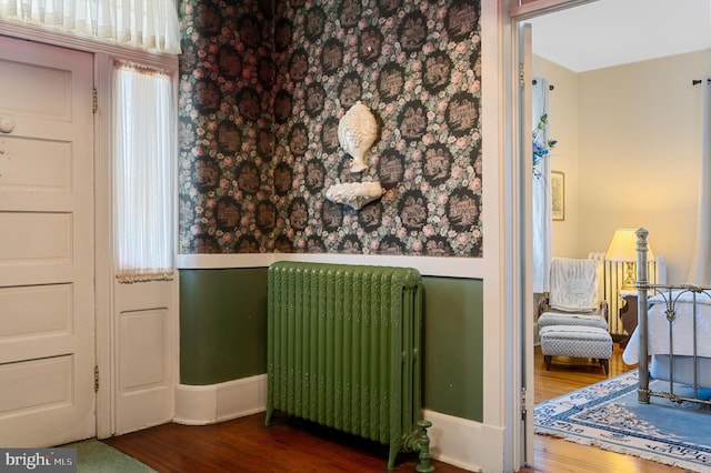 room details featuring wood-type flooring and radiator heating unit