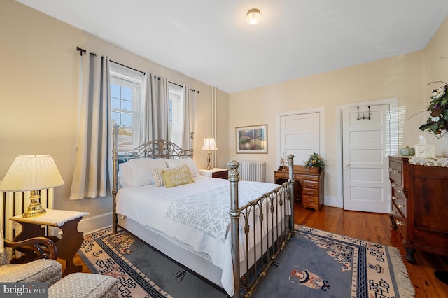 bedroom featuring radiator and dark wood-type flooring