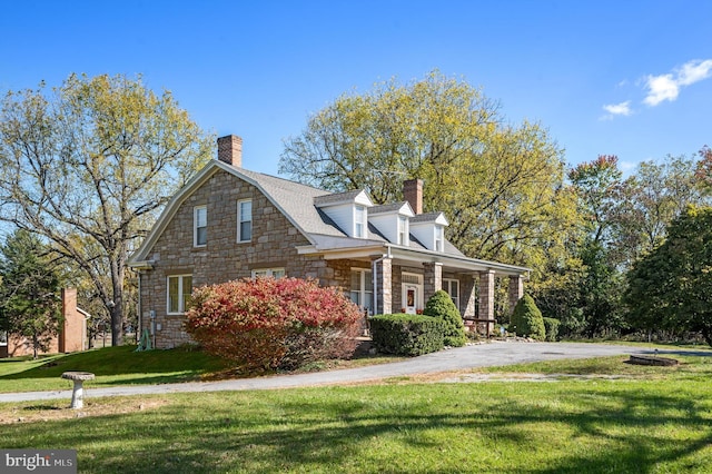 cape cod house with a porch and a front yard