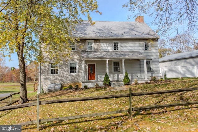 view of front of property with a porch and a front yard