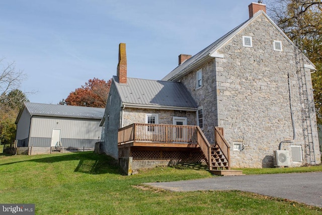 back of house with a yard and a deck