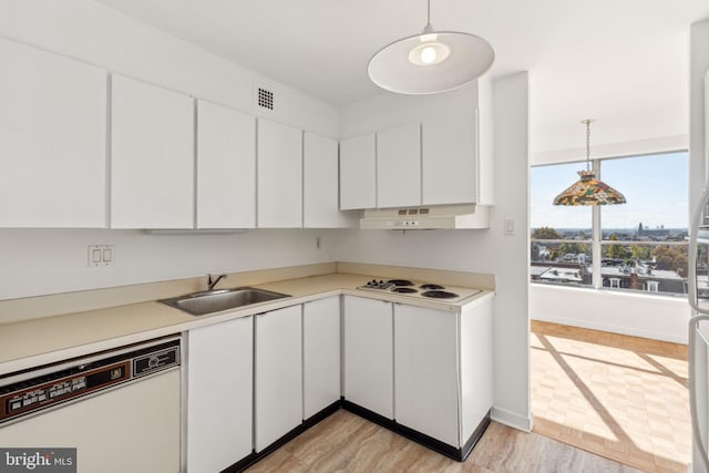 kitchen featuring hanging light fixtures, white appliances, white cabinets, and light hardwood / wood-style floors