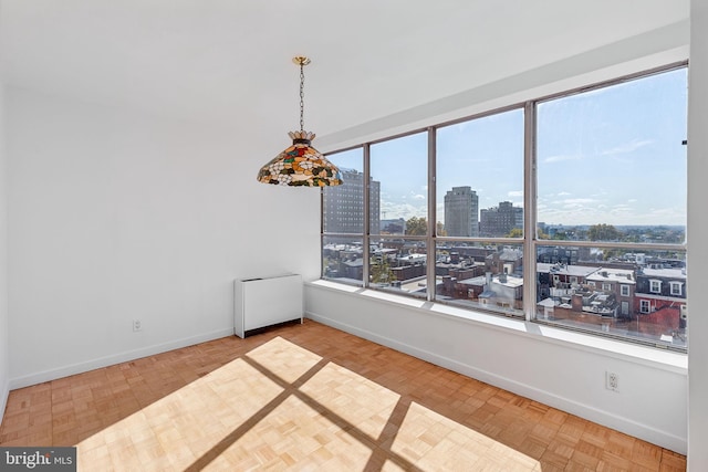 spare room with radiator and parquet floors