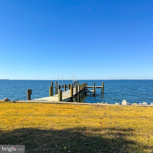 dock area with a water view and a lawn