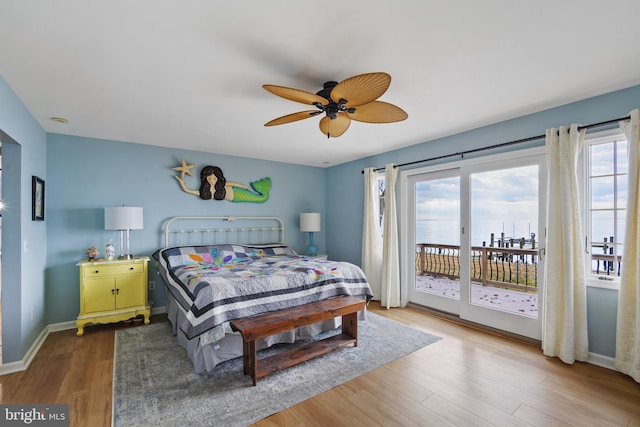 bedroom featuring ceiling fan, hardwood / wood-style flooring, and access to exterior