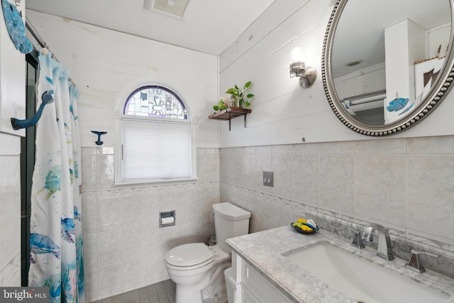 bathroom featuring tile walls, tile patterned floors, vanity, a shower with shower curtain, and toilet