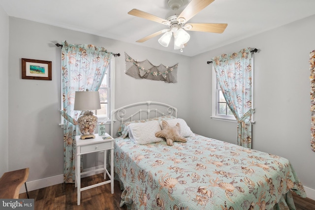 bedroom with dark hardwood / wood-style flooring, multiple windows, and ceiling fan