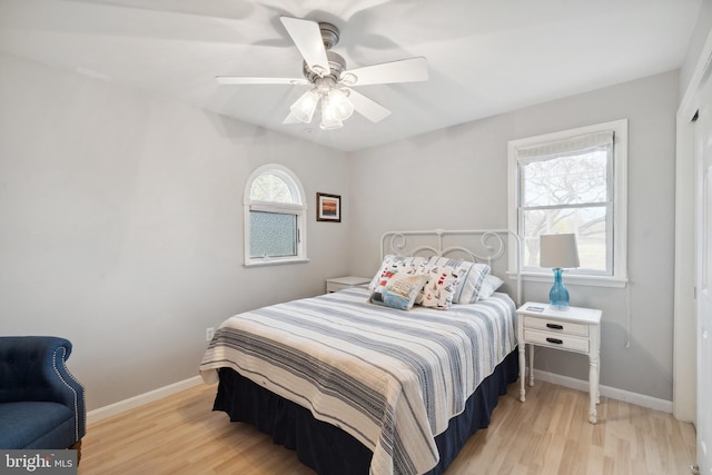 bedroom with light hardwood / wood-style floors and ceiling fan