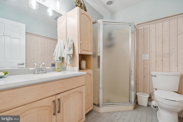 bathroom with toilet, vanity, tile patterned flooring, and a shower with shower door