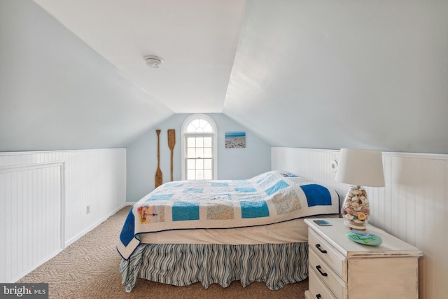 bedroom with light carpet and lofted ceiling