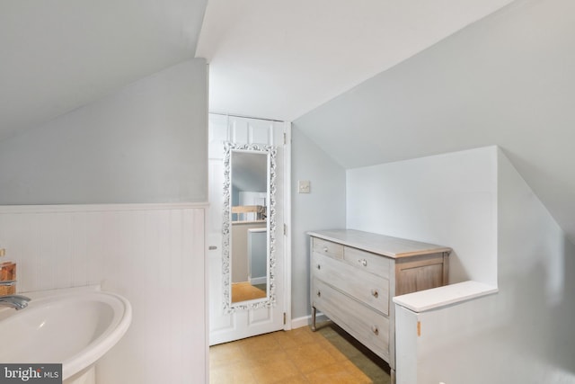 bathroom with lofted ceiling and sink