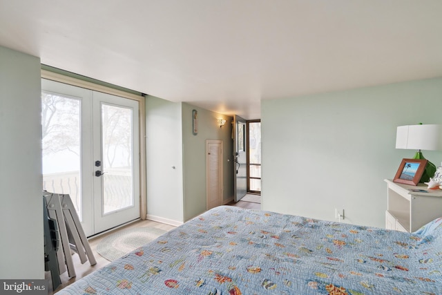 bedroom featuring french doors, access to outside, and light hardwood / wood-style floors